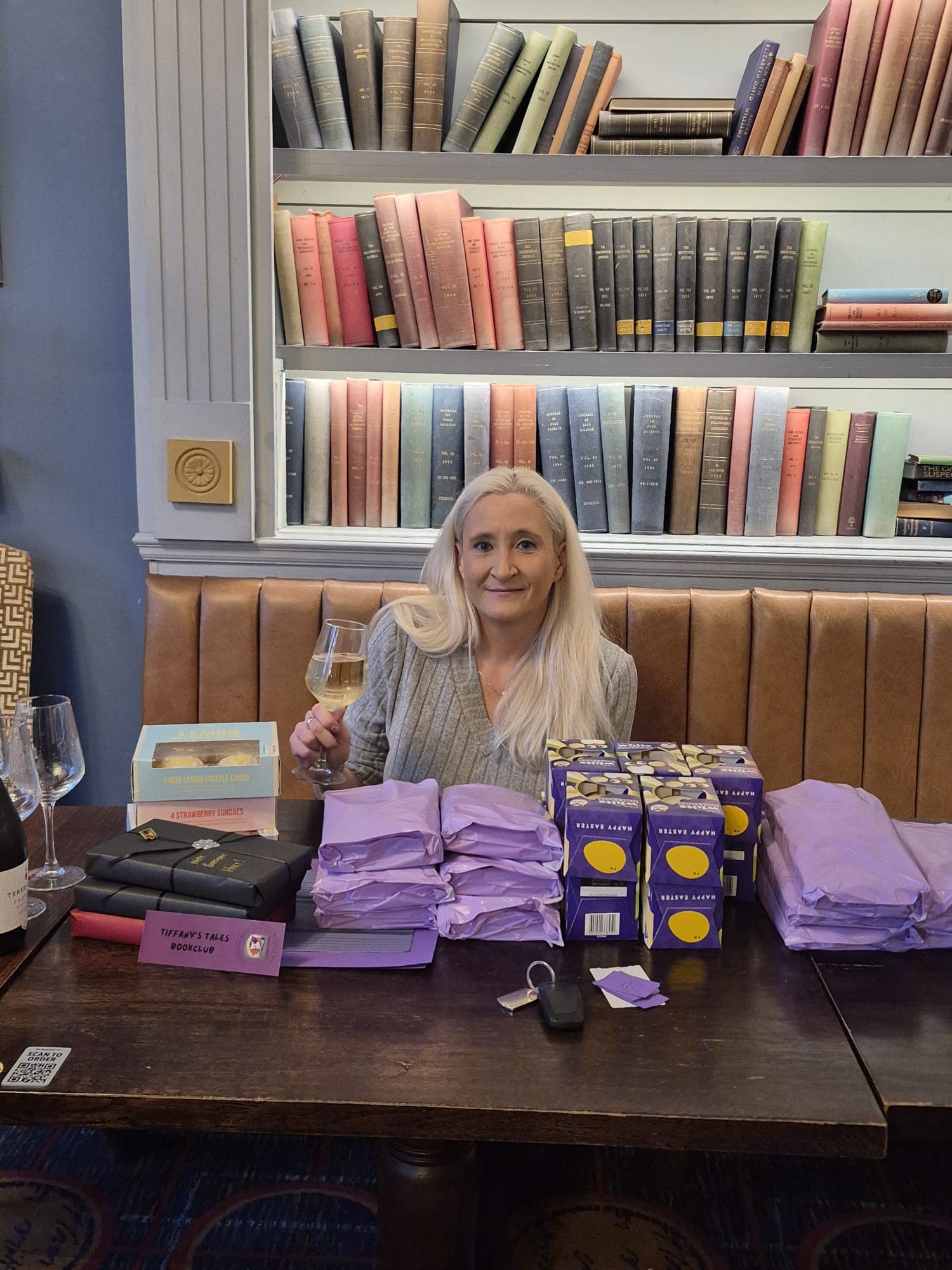 Riette hosting a Tiffany's Tales meet-up, books and goodie bags set out on the table